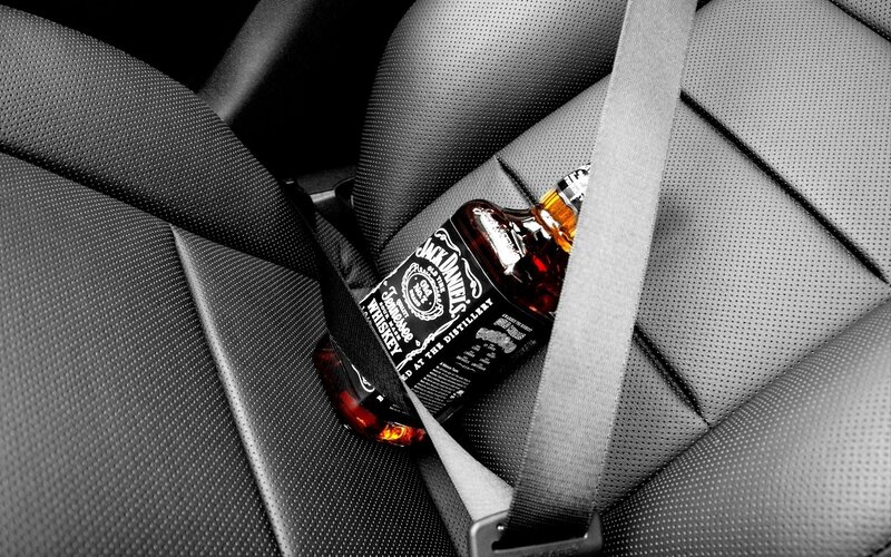 Jack Daniel's Bottle in Car — Black, Dramatic