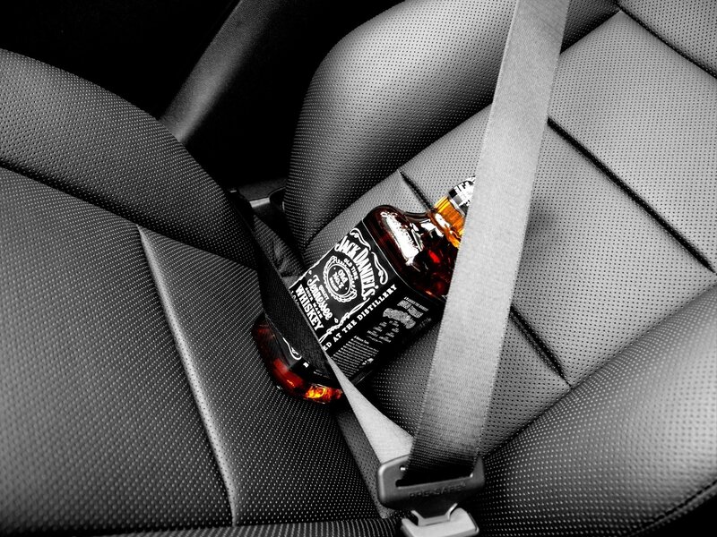 Jack Daniels bottle in car seat