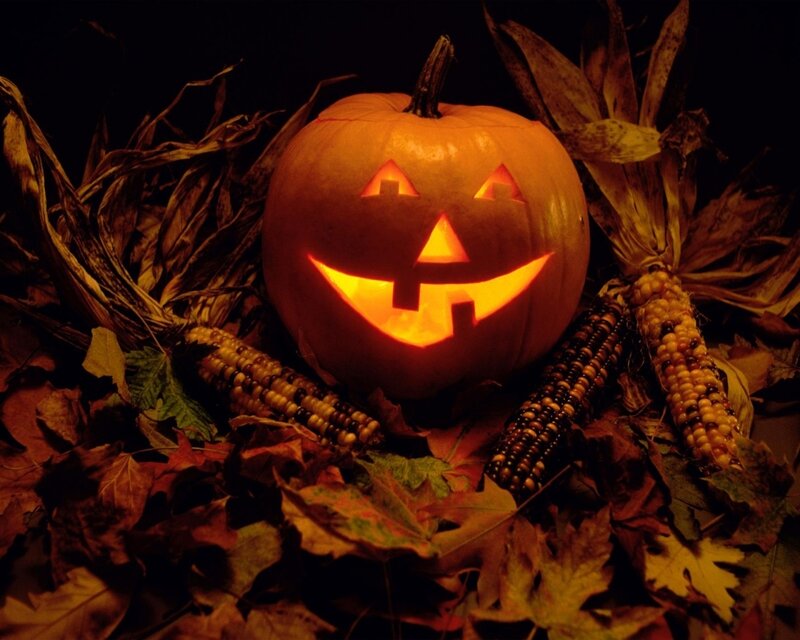 Jack-o'-lantern with corn and leaves