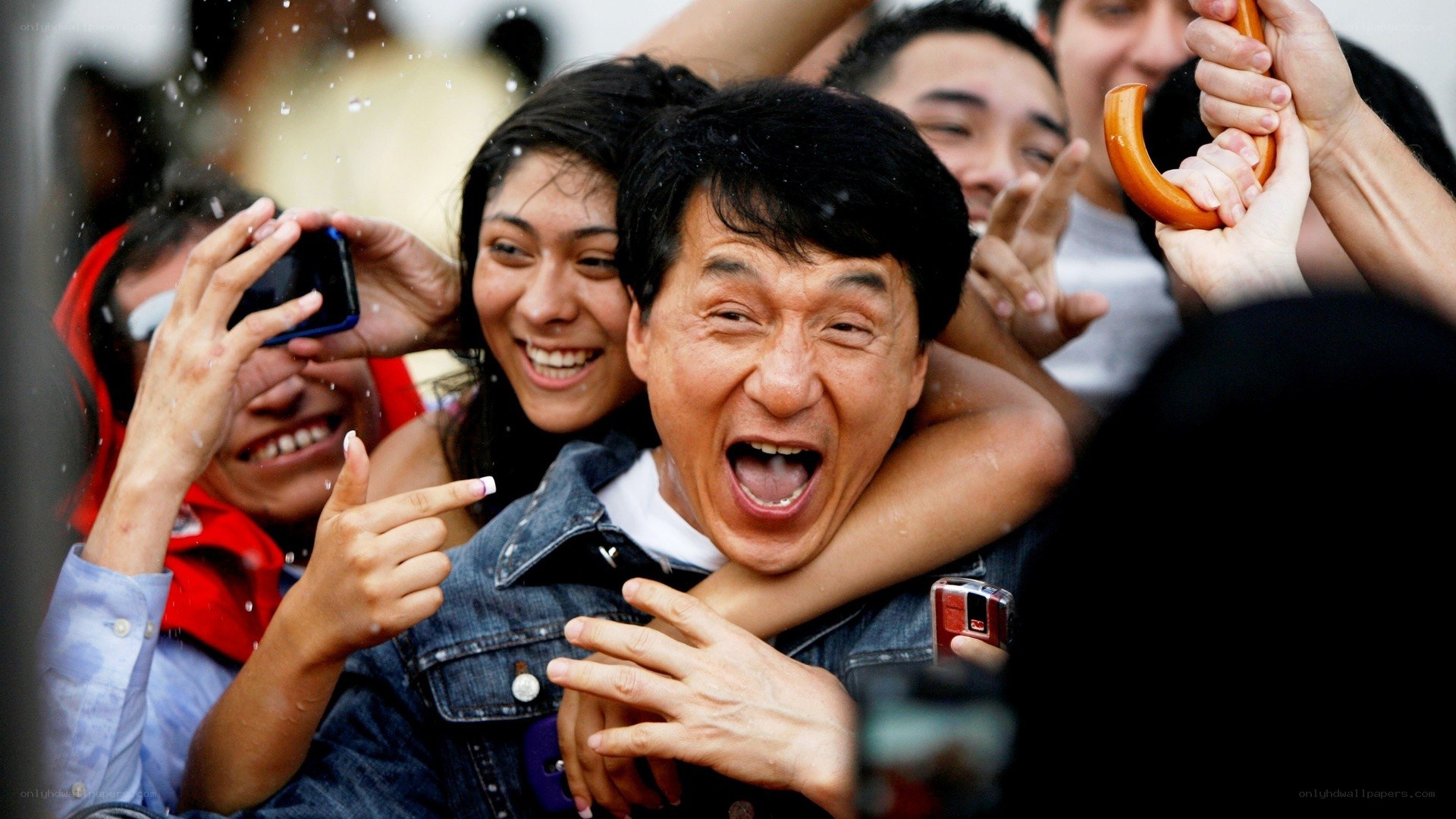 Jackie Chan surrounded by fans