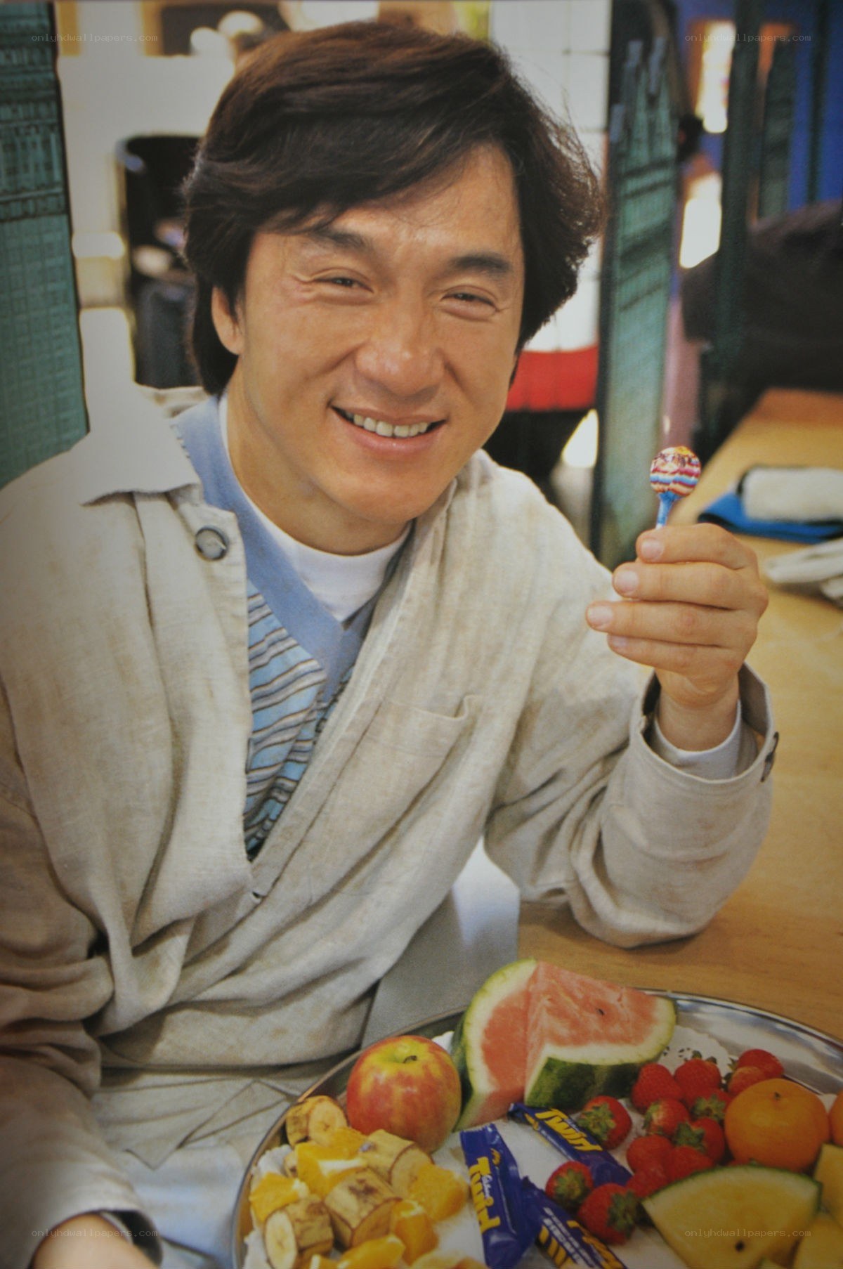 Jackie Chan with fruit and lollipop