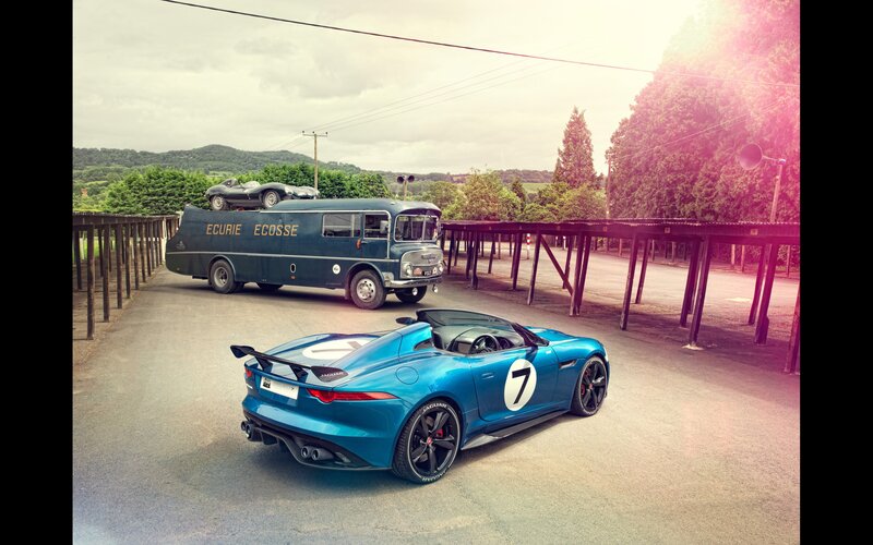 Jaguar and vintage bus at racetrack