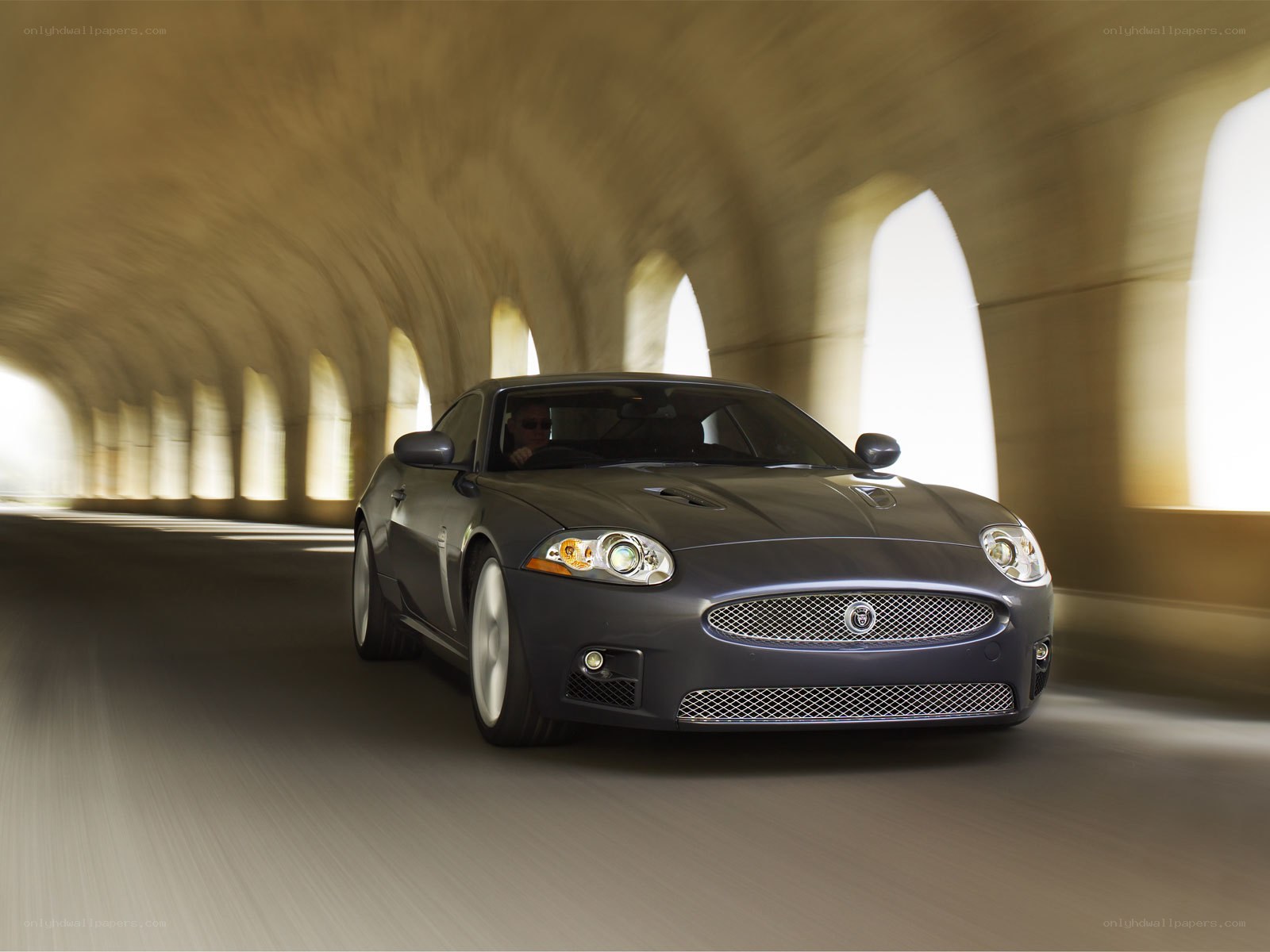 Jaguar car driving through tunnel
