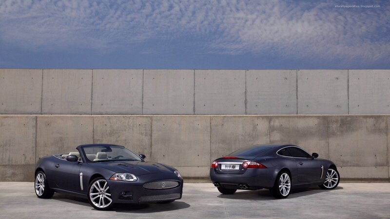 Jaguar cars against concrete wall