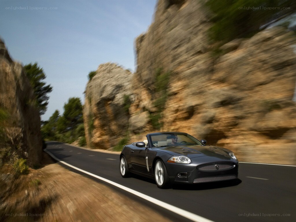 Jaguar convertible on winding road