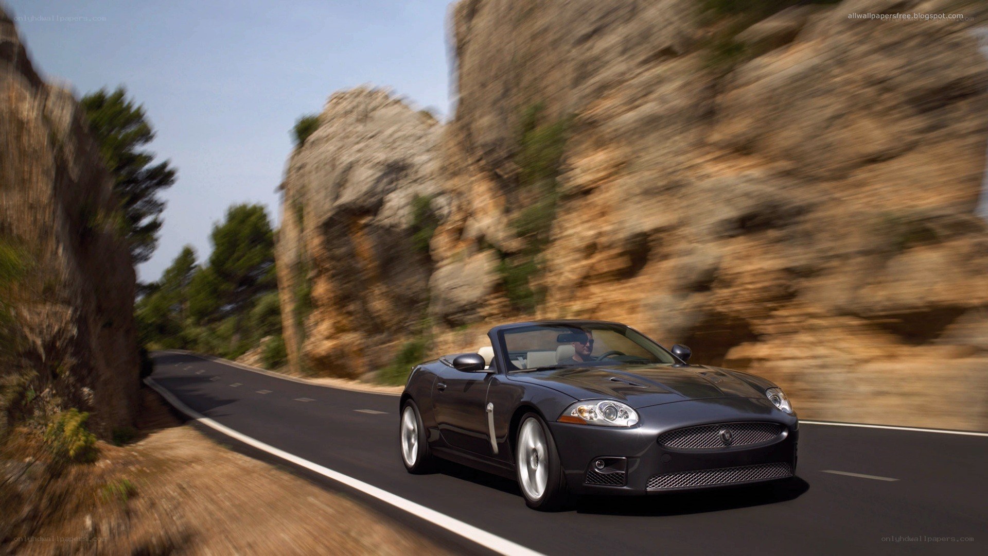 Jaguar convertible on winding road