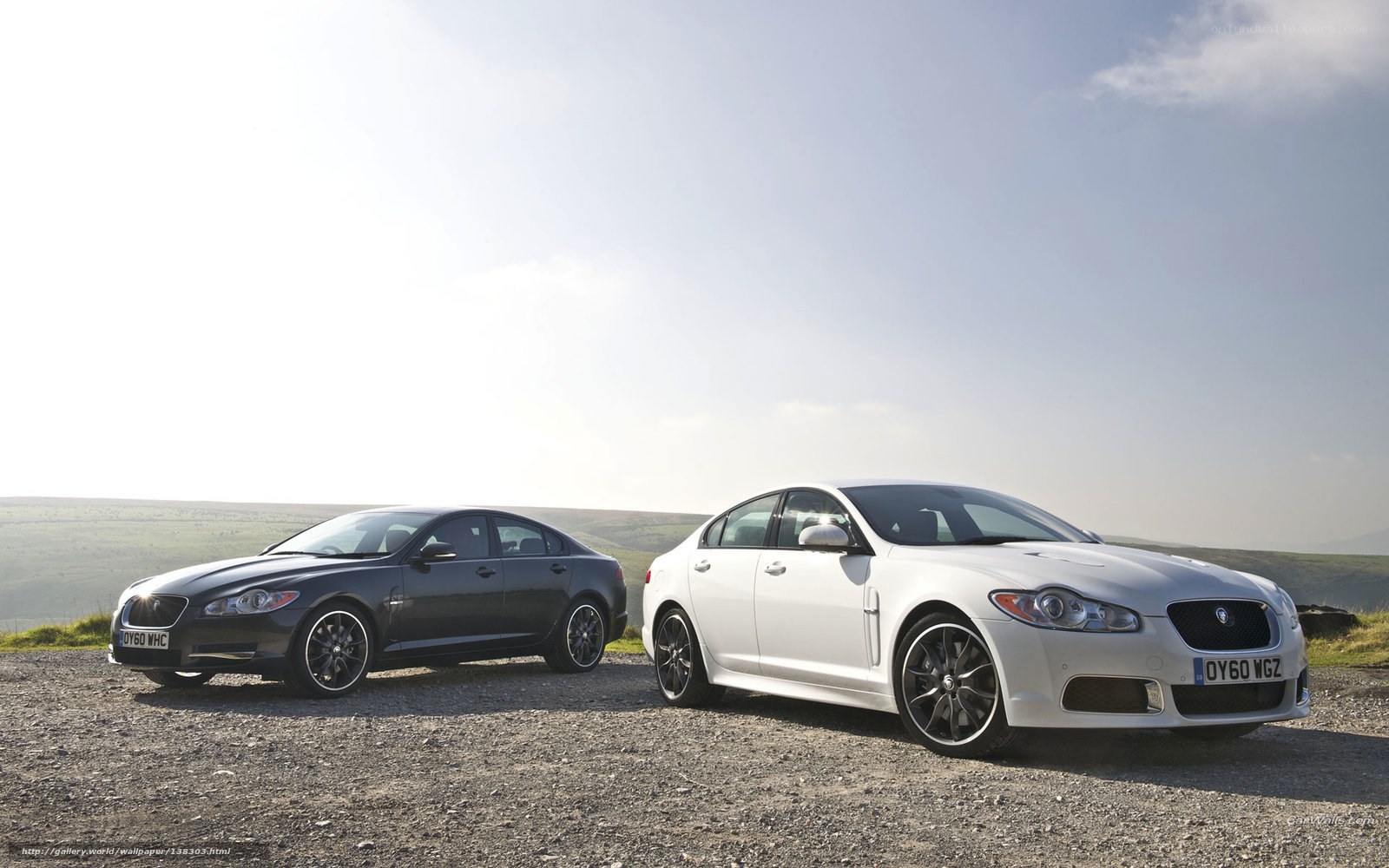 Jaguar sedans on gravel