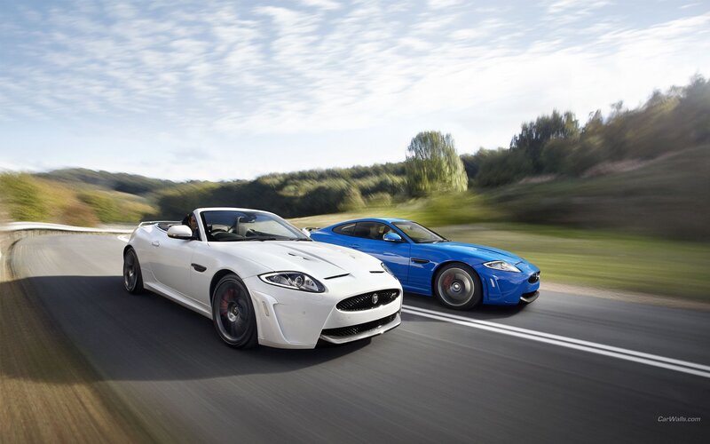 Jaguar sports cars on a road
