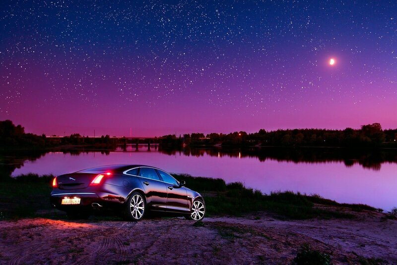 Jaguar XJ by a lake at night