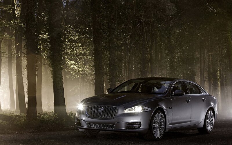 Jaguar XJ in a misty forest
