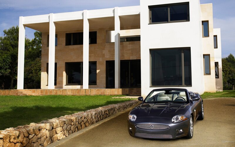 Jaguar XK convertible in front of modern house