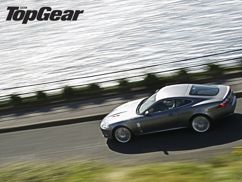 Jaguar XK speeding on coastal road