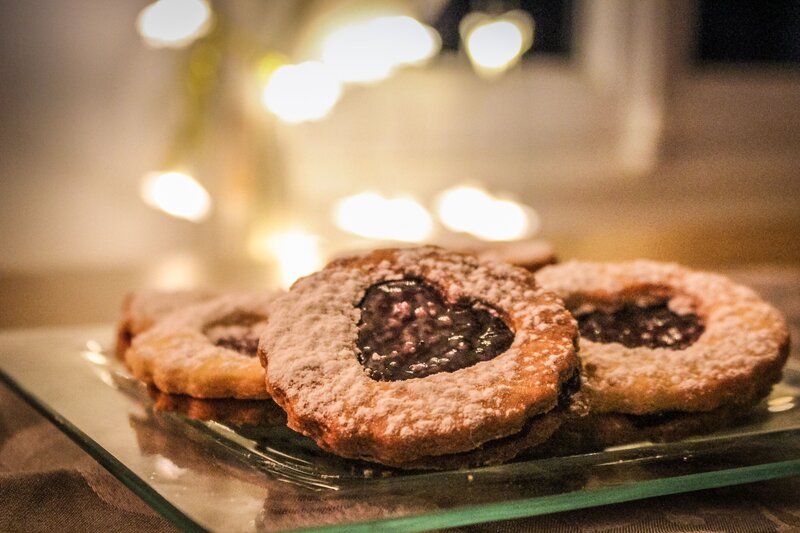 Jam-filled cookies on glass plate