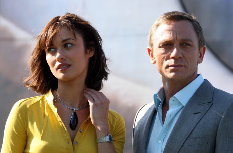 James Bond and a woman standing together