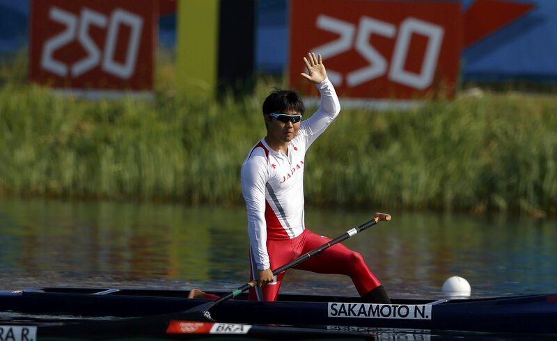 Japanese rower waves after race