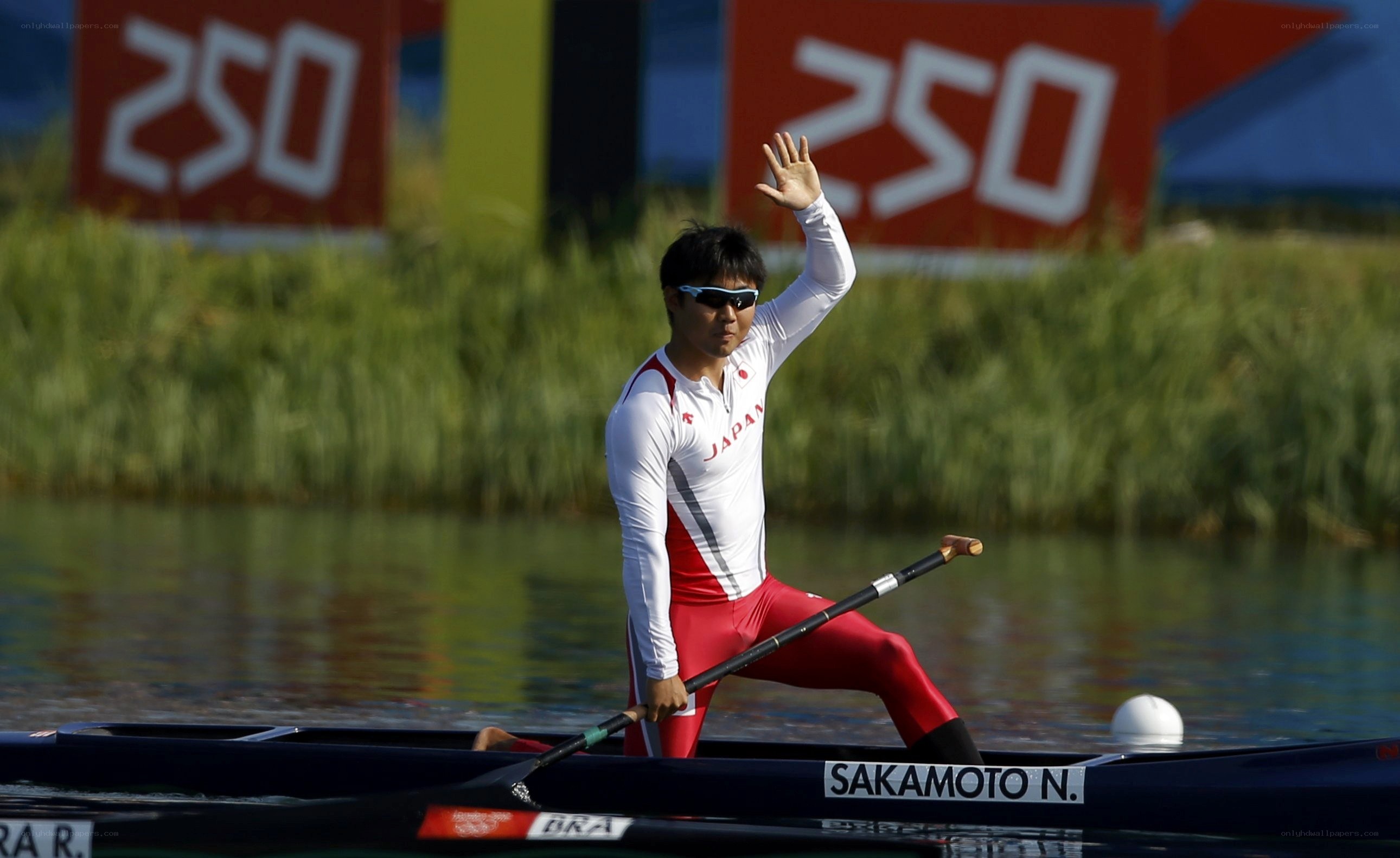 Japanese rower waves after race