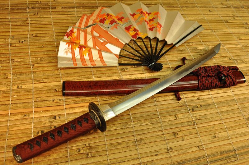 Japanese sword and fan on mat
