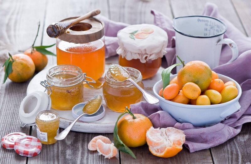 Jars of Honey and Citrus Fruits