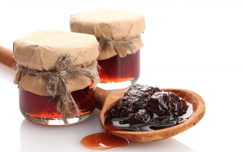 jars of jam with wooden spoon