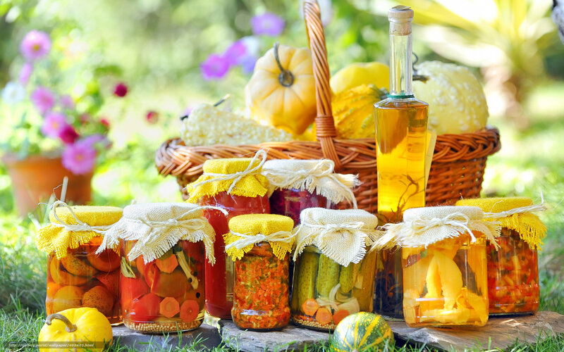 Jars of pickled vegetables in garden
