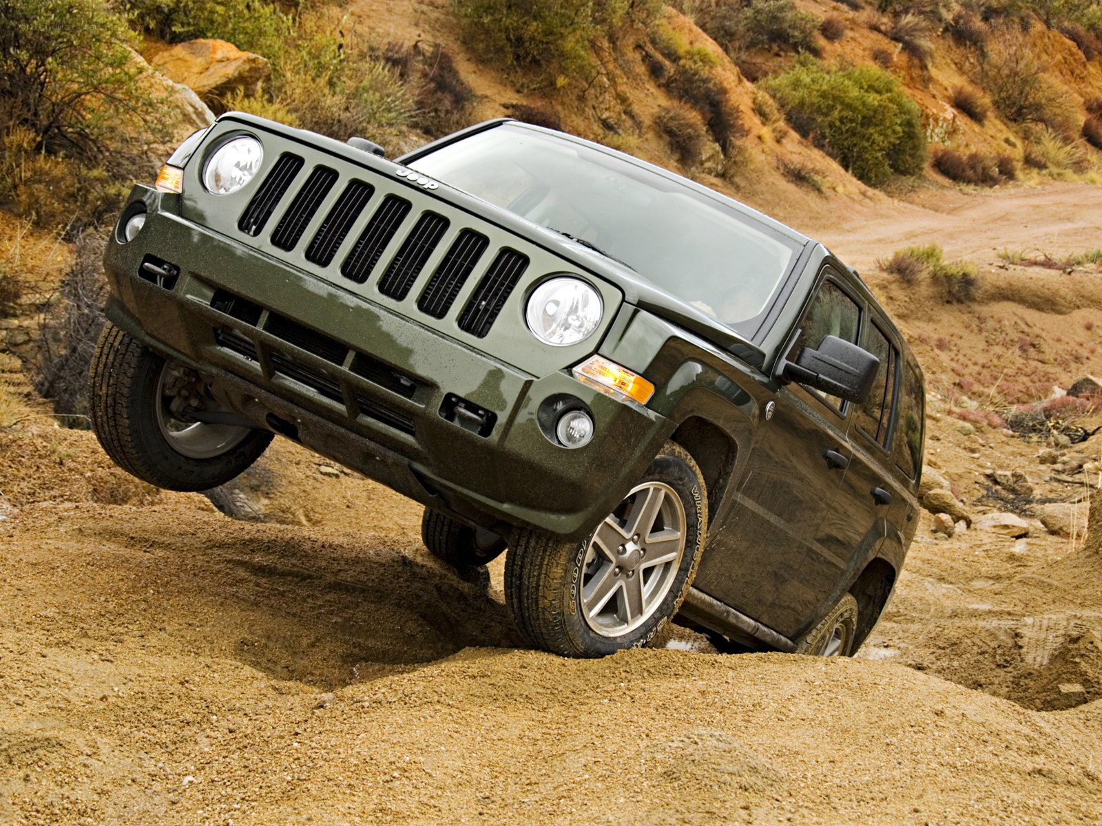 Jeep climbing a dirt hill