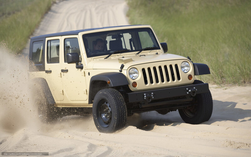 Jeep driving on sandy path