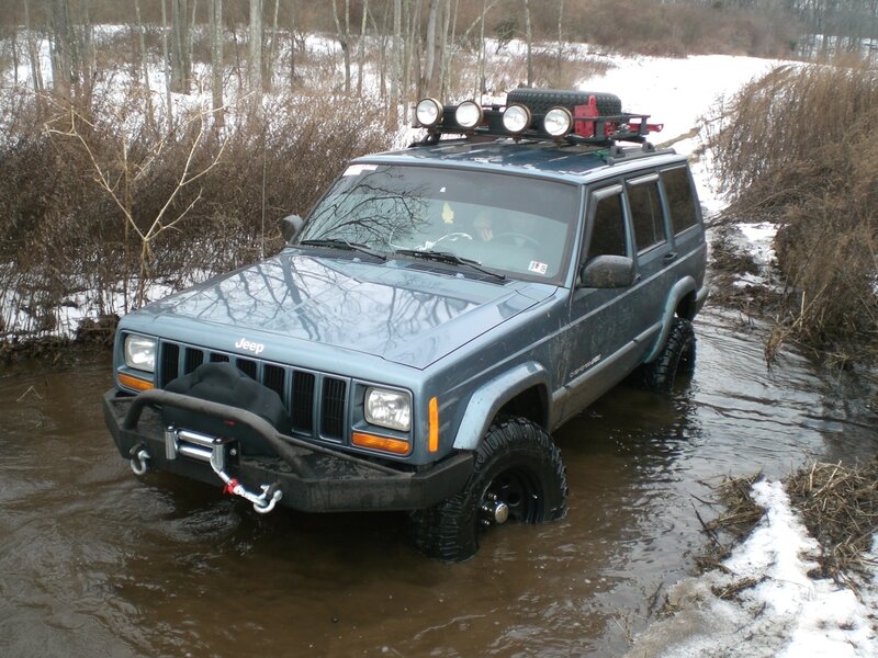Jeep driving through a stream