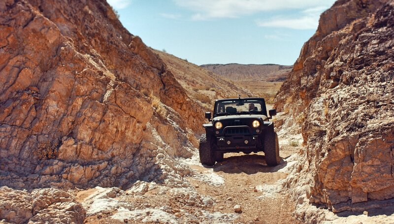 Jeep driving through canyon