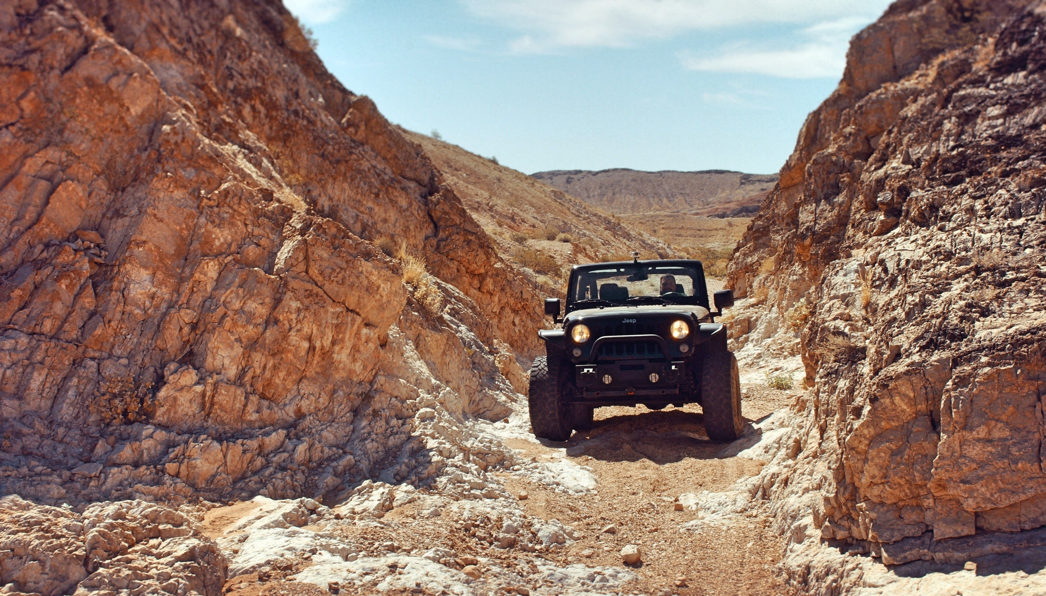 Jeep driving through canyon