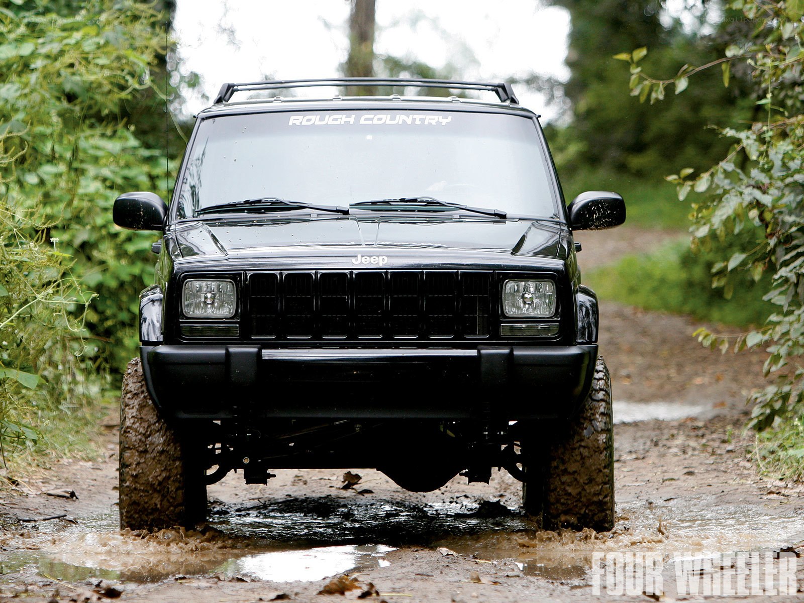 Jeep driving through mud
