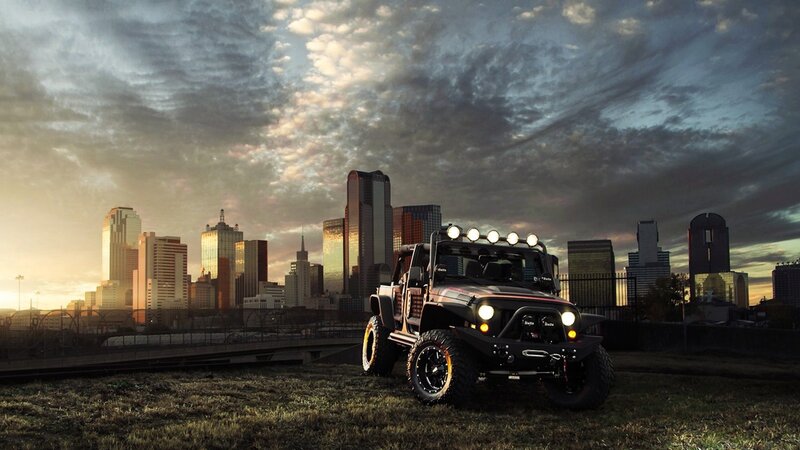 Jeep in city at sunset