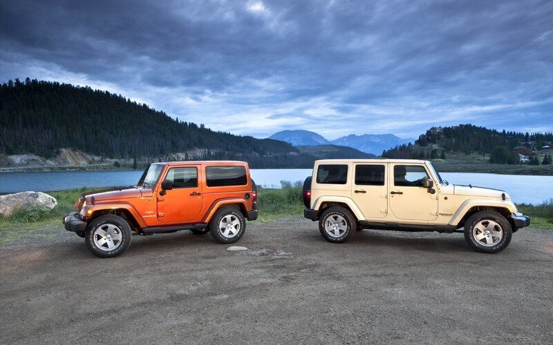 Jeeps by a lake at dusk