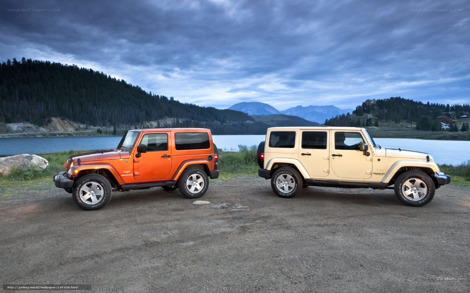 Jeeps by a lake at dusk