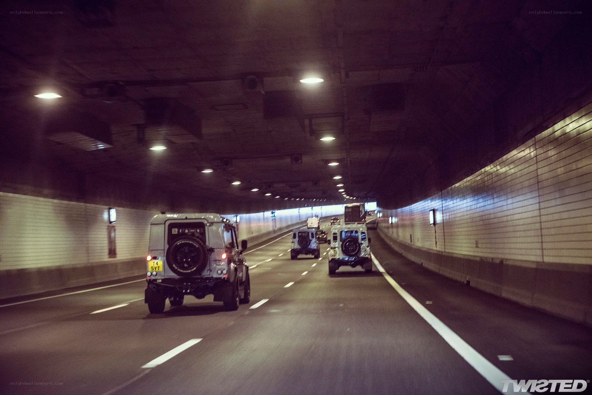 Jeeps driving through a tunnel