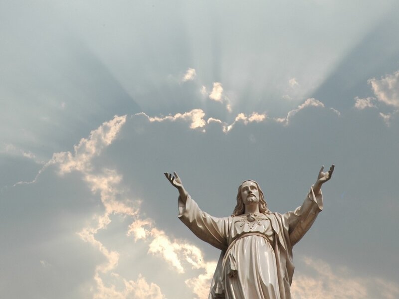 Jesus statue with sun rays