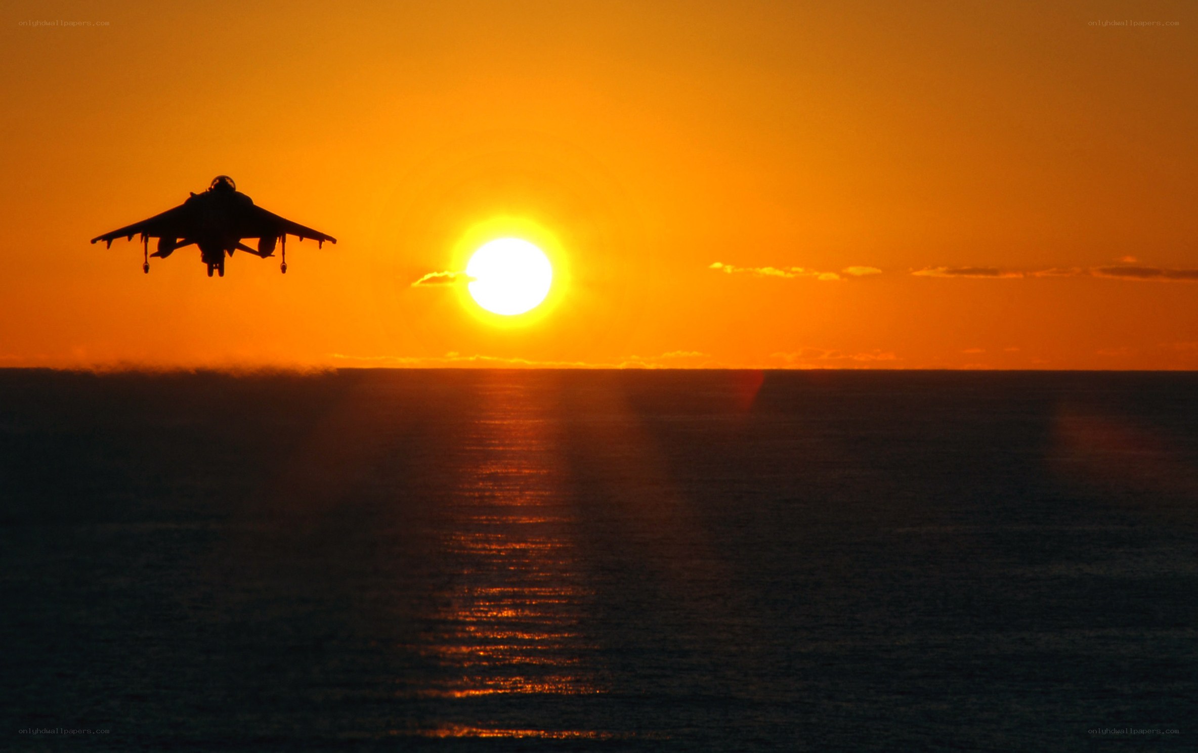 Jet aircraft at sunset over ocean