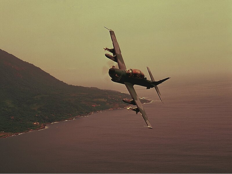 Jet aircraft flying over coastline