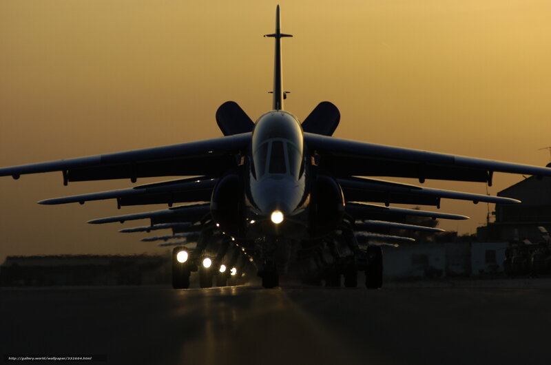 Jet aircraft on runway at sunset
