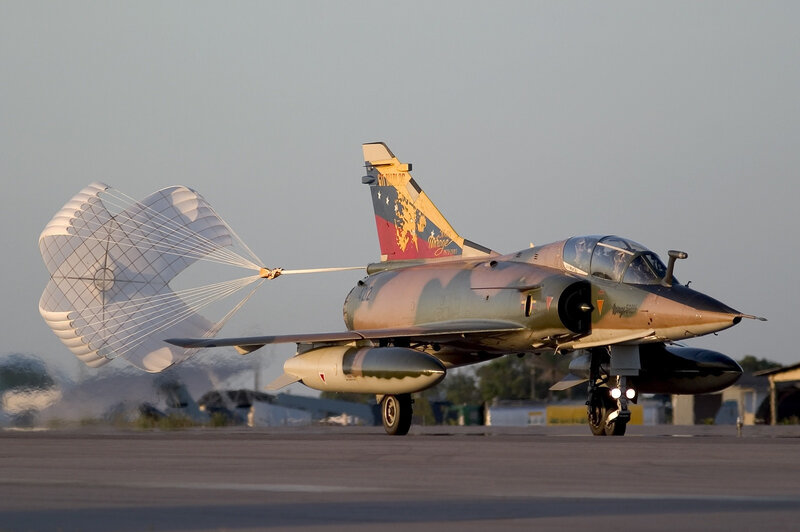 Jet aircraft with parachute on runway