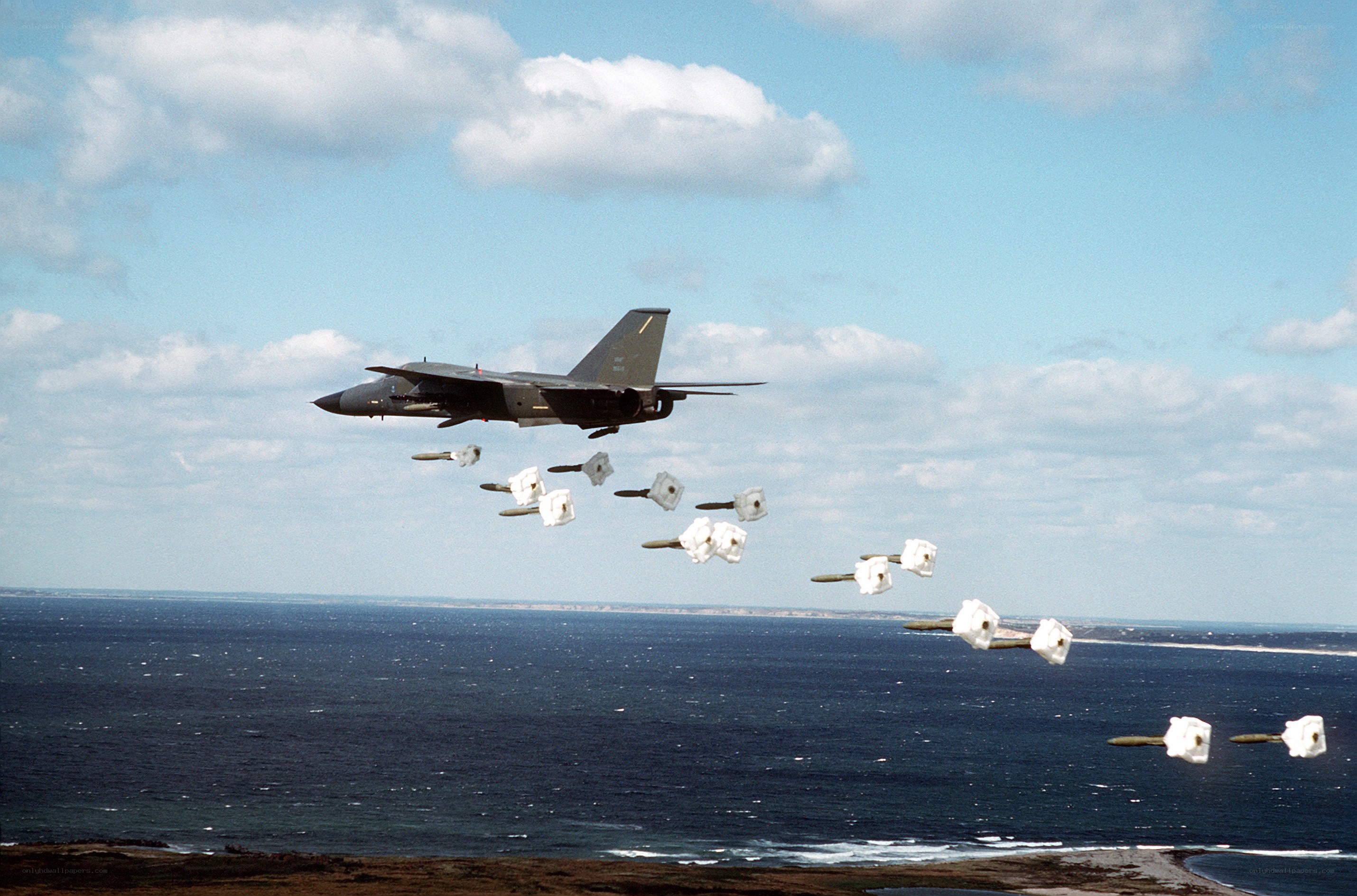 Jet dropping bombs over ocean
