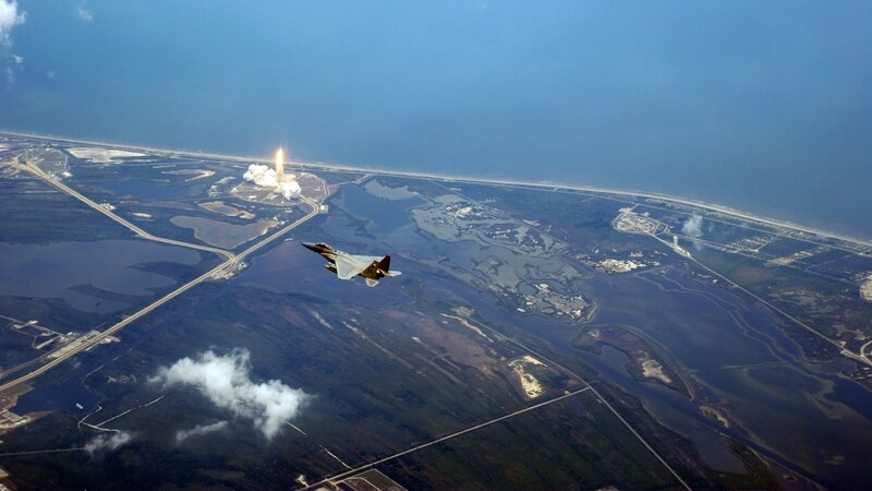 Jet escorting rocket launch