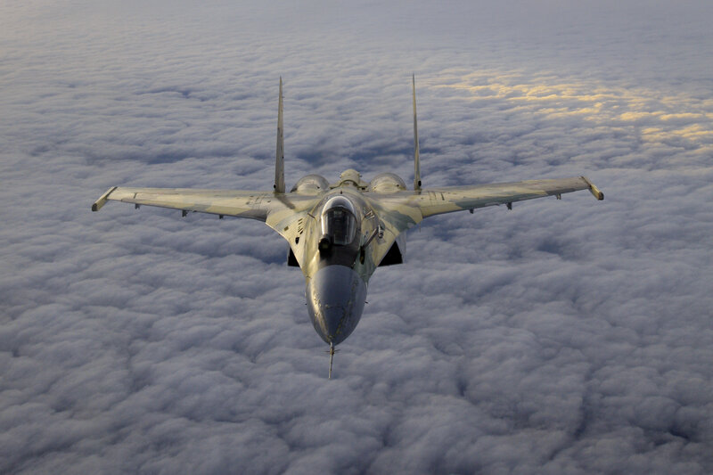Jet fighter above clouds