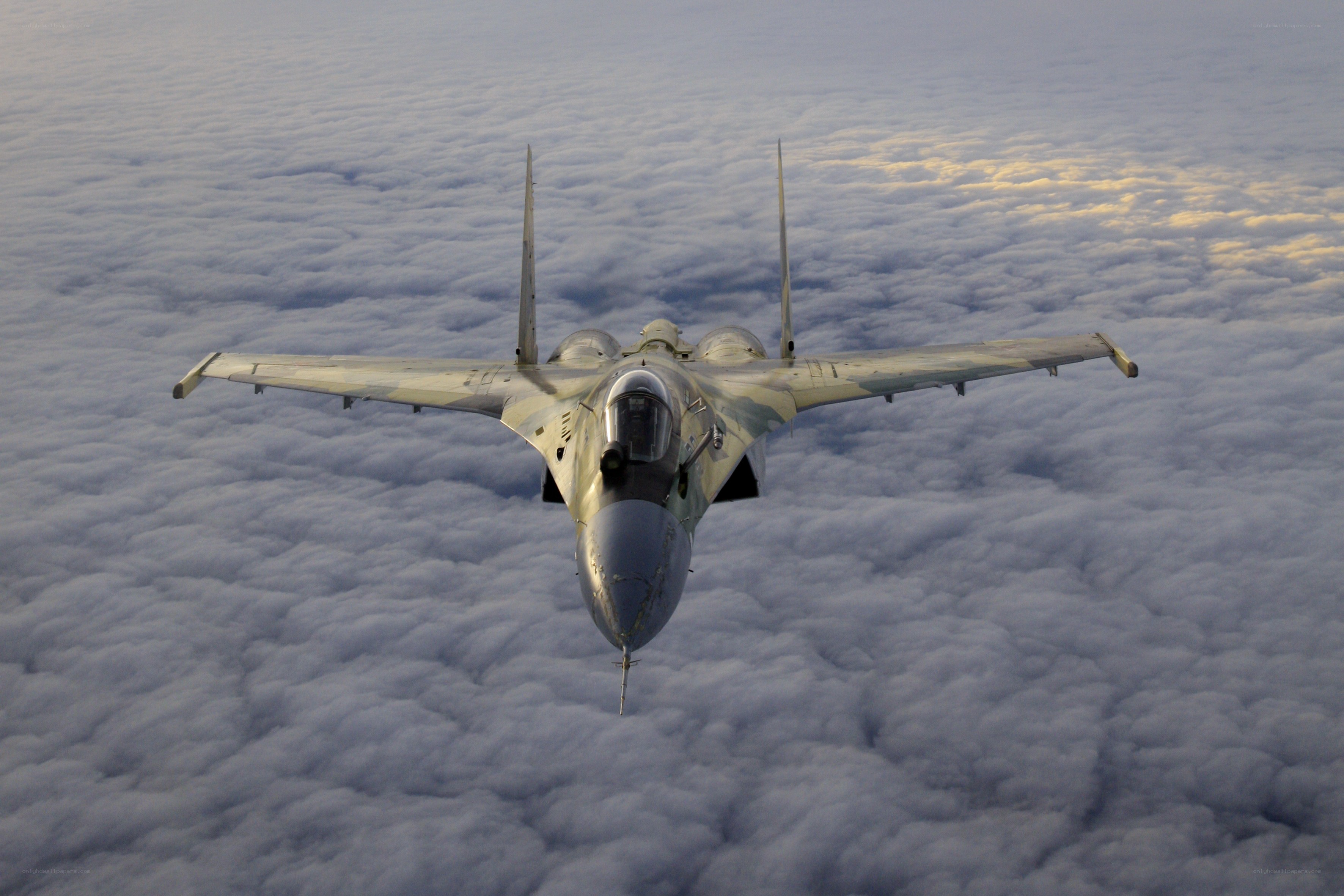 Jet fighter above clouds