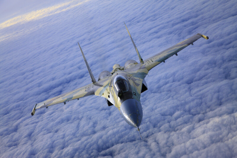 Jet fighter above clouds