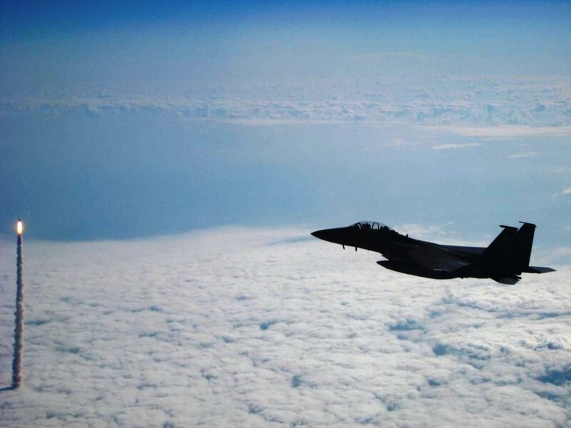 Jet fighter and rocket launch