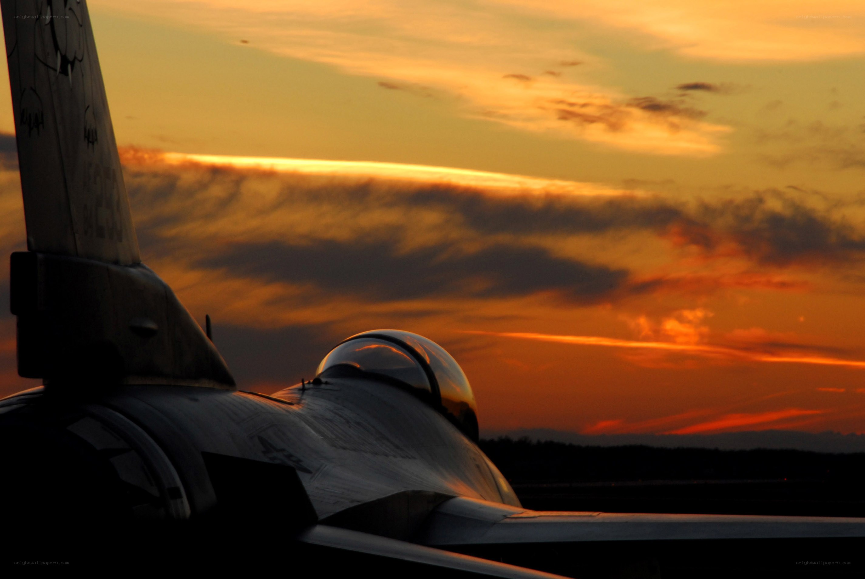 Jet fighter at sunset