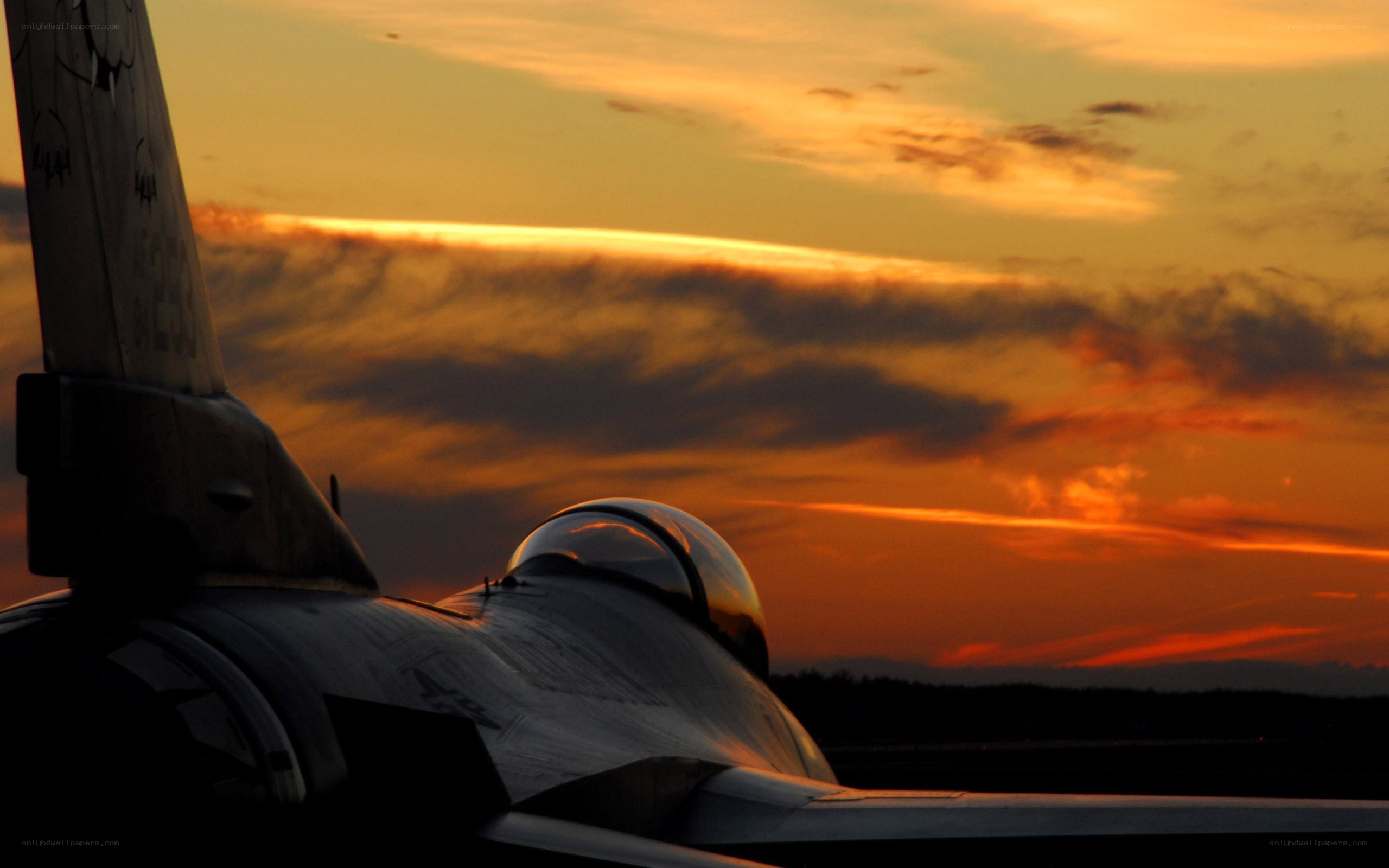Jet fighter at sunset