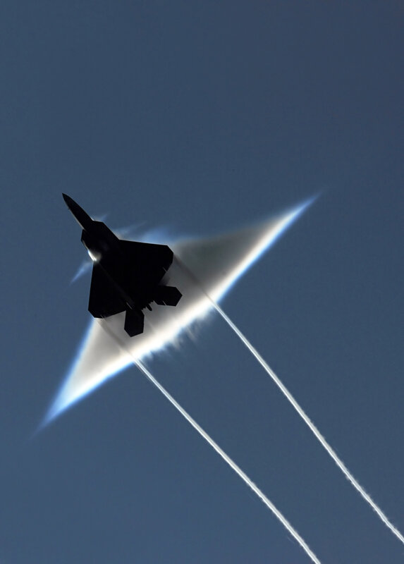 Jet fighter breaking sound barrier