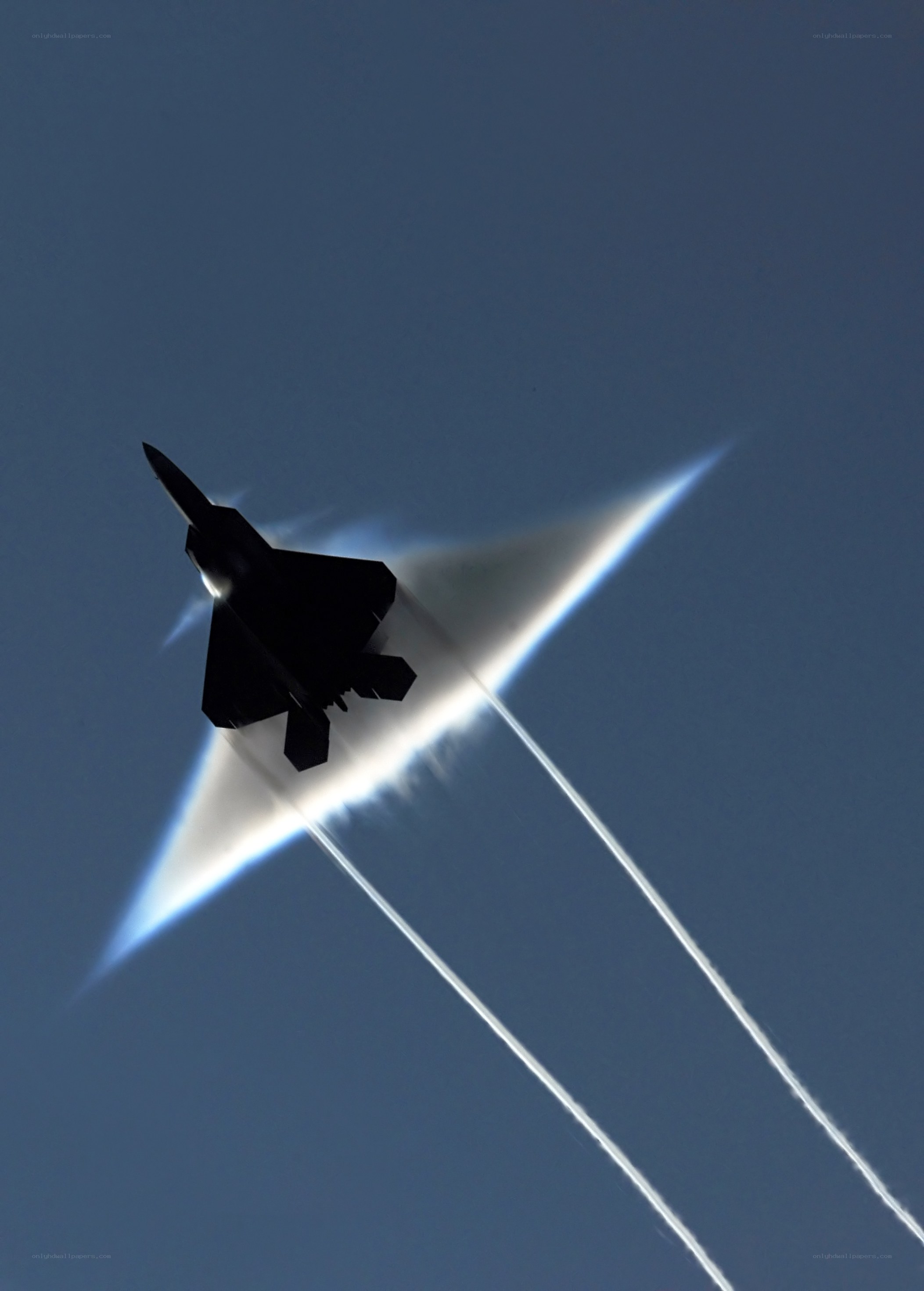 Jet fighter breaking sound barrier