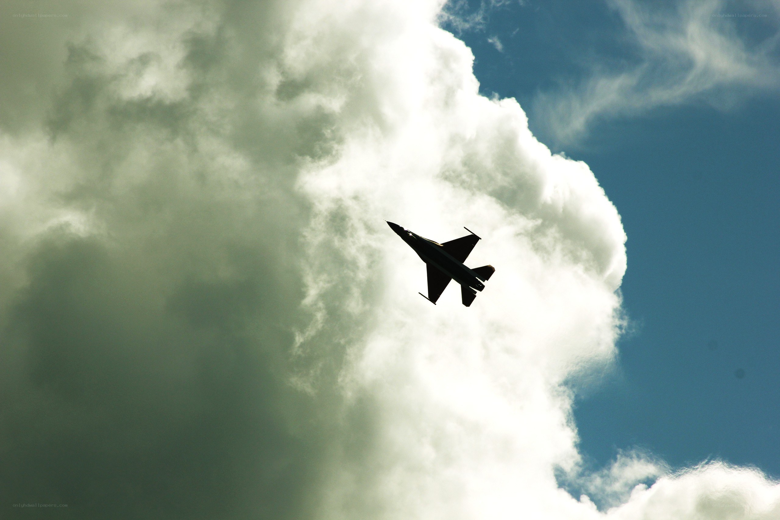 Jet fighter in cloudy sky